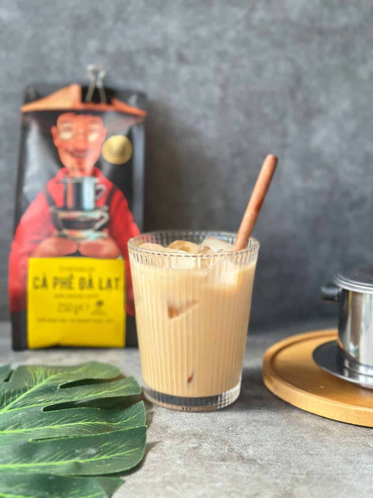 A glass of Vietnamese iced coffee, cà phê sữa đá, with coffee, condensed milk, and ice.