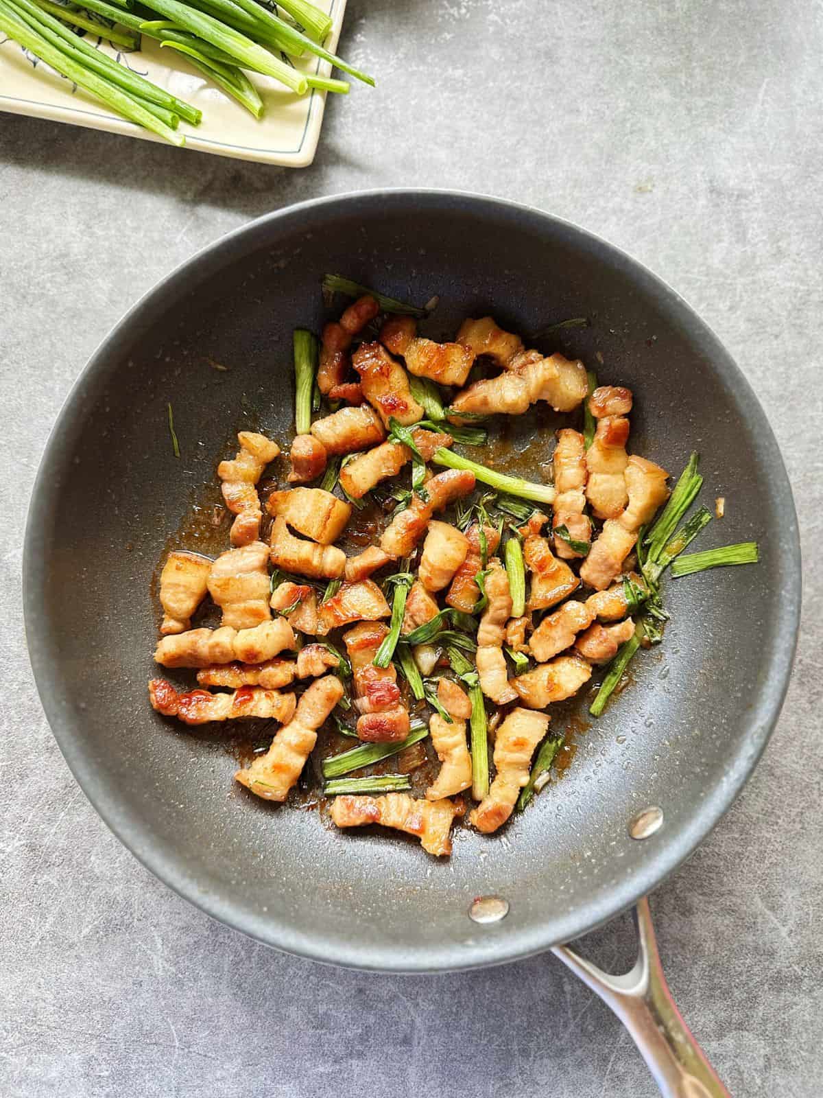 Skillet of Vietnamese crispy caramelized pork belly with scallions (Ba Chỉ Rang Cháy Cạnh).