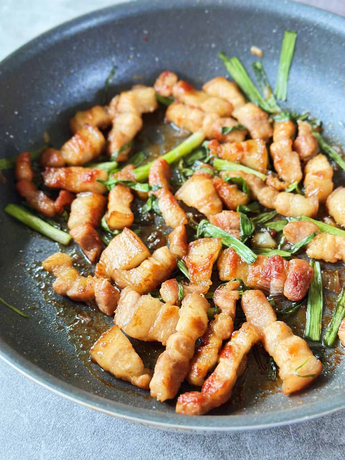 Skillet of Vietnamese crispy caramelized pork belly with scallions (Ba Chỉ Rang Cháy Cạnh).