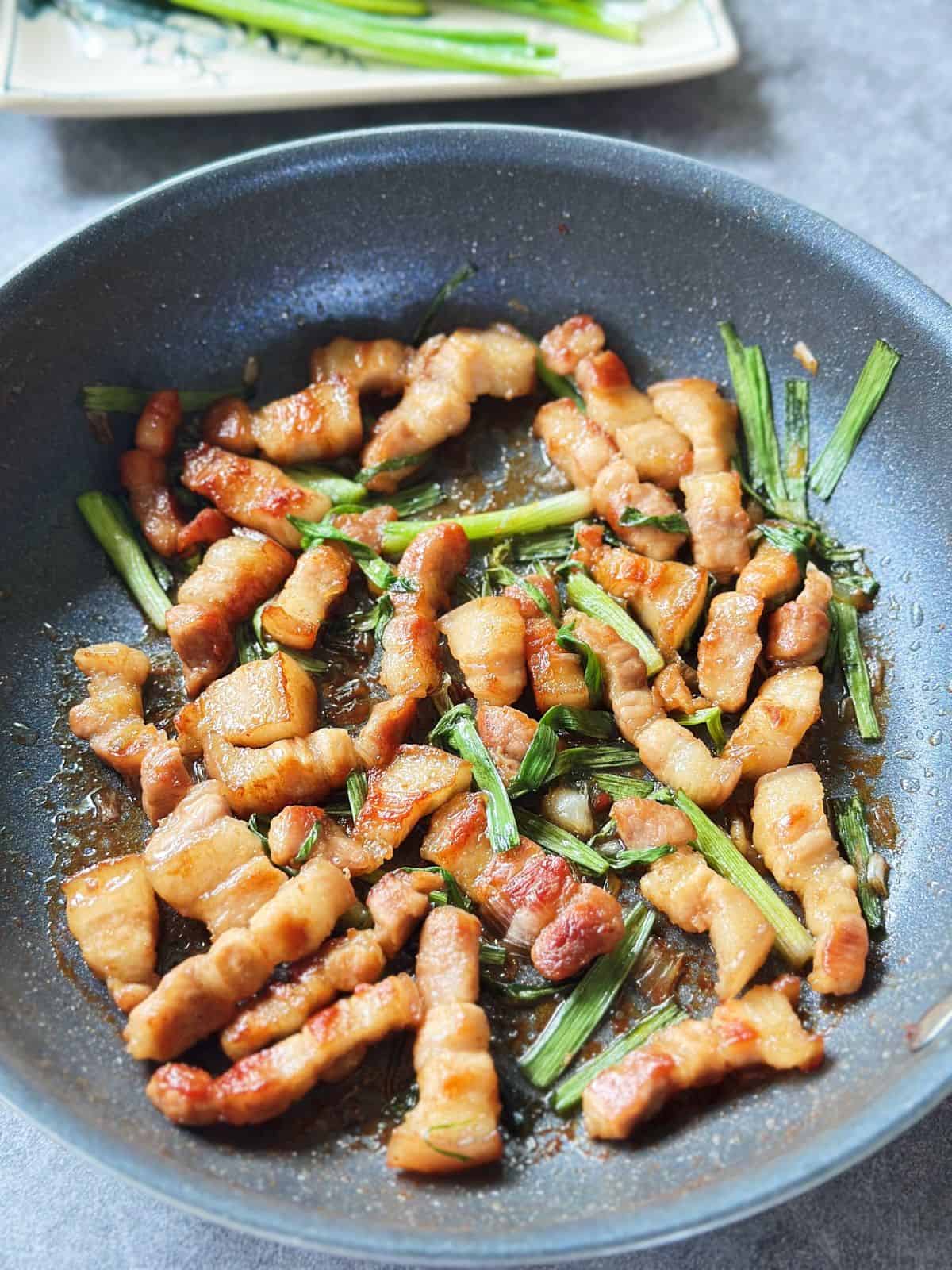 Skillet of Vietnamese crispy caramelized pork belly with scallions (Ba Chỉ Rang Cháy Cạnh).