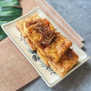 A plate of crispy Vietnamese lemongrass tofu, glazed in aromatic lemongrass and chili.