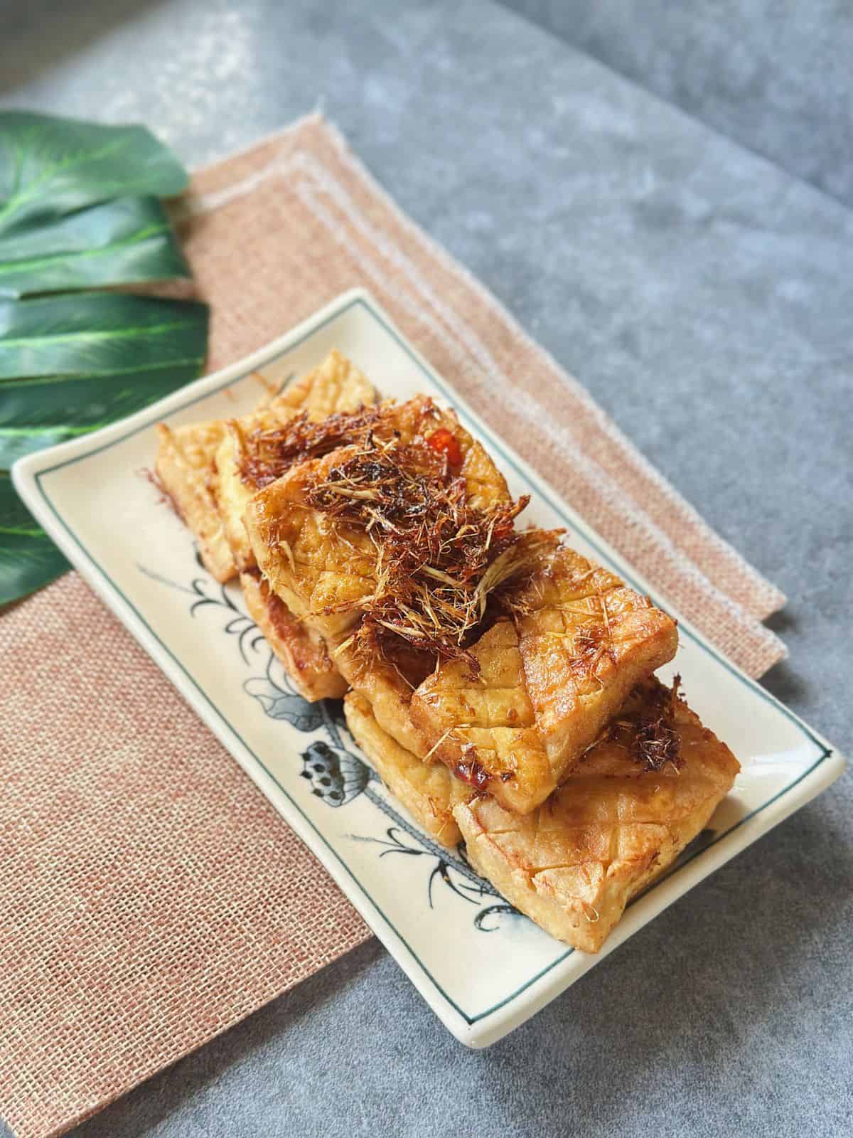 A plate of crispy Vietnamese lemongrass tofu, glazed in aromatic lemongrass and chili.