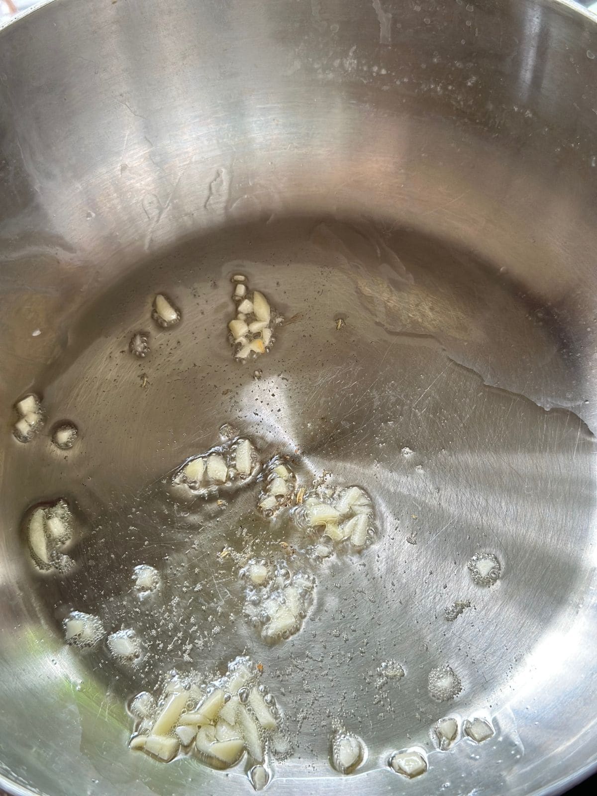 Minced garlic and ginger sizzling in a pot until fragrant.